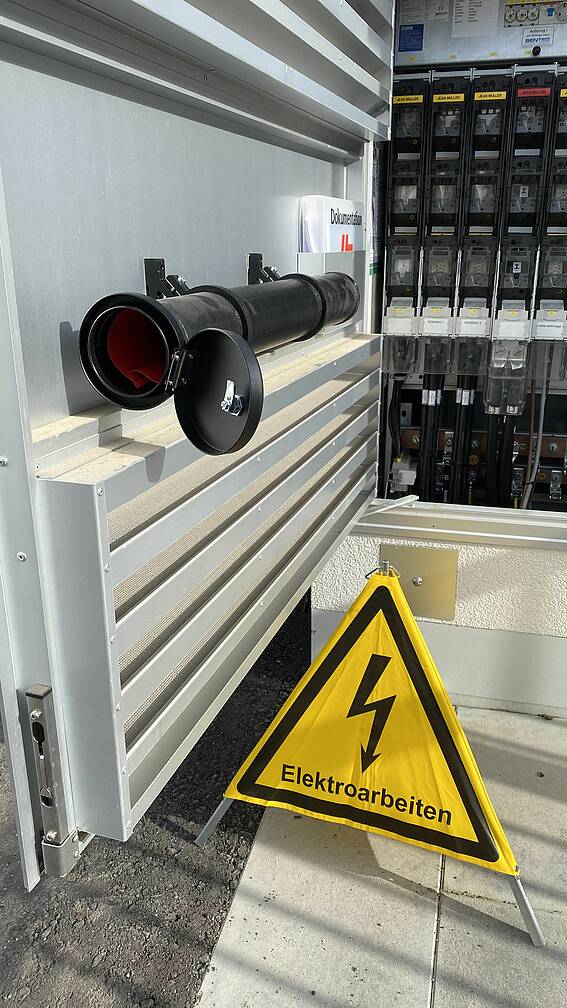 Installed and open tube container with folding sign